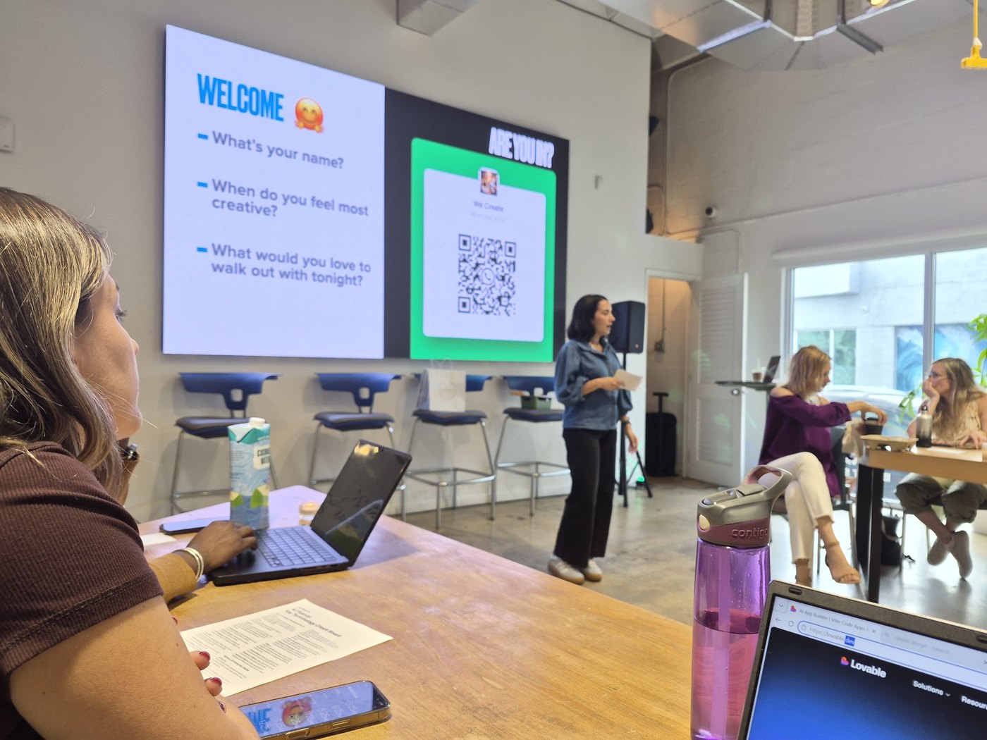 A member leading a session at the front of a We Create build night
