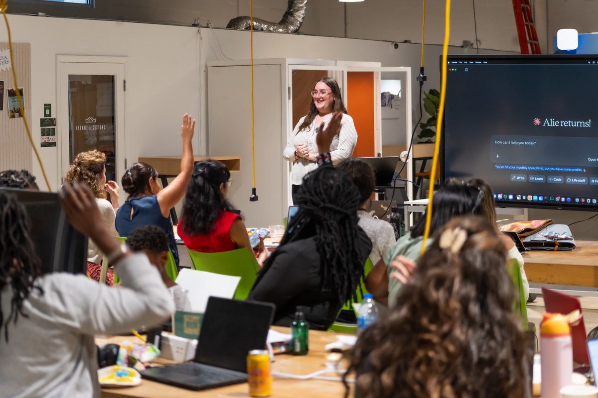 The room with hands raised during a build night
