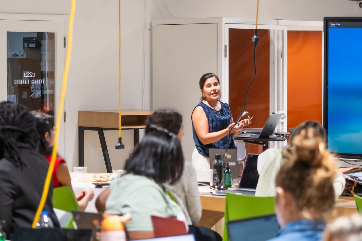 A member presenting at the front of the room