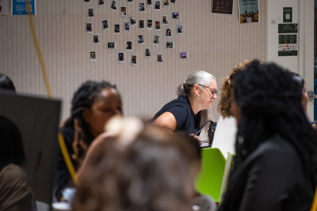A member presenting near the photo wall